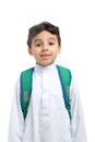 Arab school boy closeup on face with a smile and broken tooth, wearing white traditional Saudi Thobe, back pack and sneakers,
