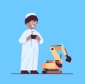 arab schoolboy playing with radio controlled tractor toy smiling boy having fun full length