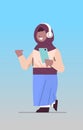 arab schoolgirl using smartphone and listening to music in headphones arabic girl with gadget vertical