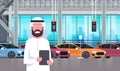 Arab Seller Man In Cars Dealership Center Showroom Interior Over Set Of New Modern Vechicles Royalty Free Stock Photo