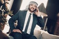 Arab sitting on couch and speaking on phone