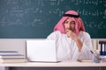 The arab teacher in front of chalkboard Royalty Free Stock Photo