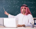 Arab teacher in front of chalkboard Royalty Free Stock Photo