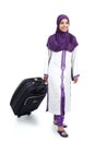 Arab traveler woman walking carrying a suitcase