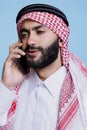 Arab in ghutra chatting on smartphone Royalty Free Stock Photo