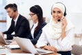 An Arab woman works in a call center.