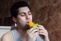 Arab young man eating mango fruit Royalty Free Stock Photo