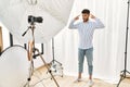Arab young man posing as model at photography studio smiling pointing to head with both hands finger, great idea or thought, good Royalty Free Stock Photo