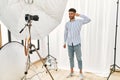 Arab young man posing as model at photography studio smiling pointing to head with one finger, great idea or thought, good memory Royalty Free Stock Photo