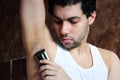 Arab young man shaving armpit hair with hair clipper Royalty Free Stock Photo