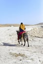 Arabian beduin man riding a donkey in the Israeli desert