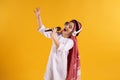 Arabian boy in keffiyeh with microphone sings karaoke. Royalty Free Stock Photo