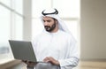 Arabian Business man using notebook in a modern office