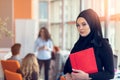 Arabian business woman holding a folder in modern startup office Royalty Free Stock Photo