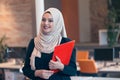 Arabian business woman holding a folder in modern startup office Royalty Free Stock Photo