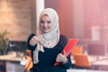 Arabian business woman holding a folder in modern startup office Royalty Free Stock Photo