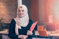 Arabian business woman holding a folder in modern startup office Royalty Free Stock Photo