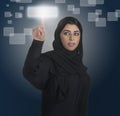 Arabian business woman pressing a touchscreen