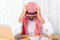 Arabian businessman feeling disappoint and suffer about his business in the office Royalty Free Stock Photo