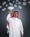 Arabian businessman pressing a touchscreen button