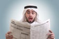 Arabian businessman shocked while reading newspape