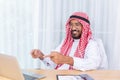 Arabian businessman smile and happy from message his computer notebook in his office Royalty Free Stock Photo