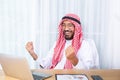 Arabian businessman smile and happy from message his computer in his office Royalty Free Stock Photo