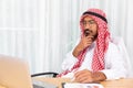 Arabian businessman is thinking about his work in his office with computer notebook Royalty Free Stock Photo