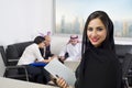 Arabian Businesswoman with Employees meeting in the background