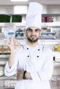 Arabian chef with OK sign in the kitchen