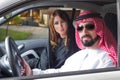 Arabian couple in a newely purchased car