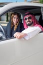 Arabian couple in a newely purchased car