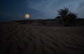 Arabian desert against huge moon Royalty Free Stock Photo