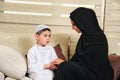 Arabian family, mother and son sitting on the couch in their living room Royalty Free Stock Photo