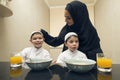Arabian family of Mother and Two kids having Breakfast in the morning