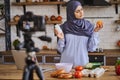 Arabian female food blogger comparing supplements and natural food