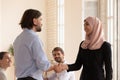 Arabian female in hijab worker handshake with boss receiving praises