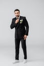 Arabian groom in suit fixing tie Royalty Free Stock Photo