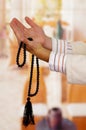 Arabian guy praying to his god and holding a masbaha