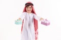 Arabian happy boy in keffiyeh presents gift boxes.