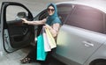 Arabian lady with shopping bags in her car. Royalty Free Stock Photo
