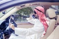 Arabian man driving a car while talking on phone Royalty Free Stock Photo