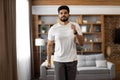 Arabian man making active fitness exercises at living room