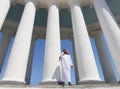 Arabian man standing in front of large columns
