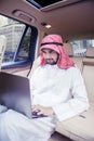 Arabian man working with a laptop computer in car Royalty Free Stock Photo