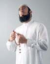 Arabian muslim man holding rosemary and praying