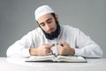 Arabian muslim man reading Quran
