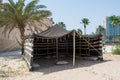 Arabian old style booth on the sand near palm trees