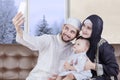 Arabian parents and boy taking selfie picture