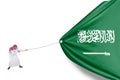 Arabian person pulls Saudi Arabia flag